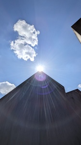 In the photo the sun is positioned at the corner of one concrete block creating sun glares