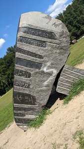 A tilted stone showing the word “hope” in various languages on it