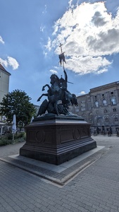 A statue is shown with a man on a horse