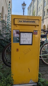 A yellow post box is shown with the text “love letters only” on the slid