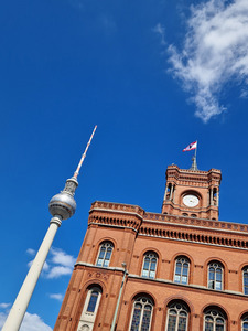 The red city hall and Berlin TV tower are shown with the sky in the background