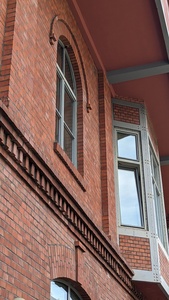 The side of a red brick building is shown