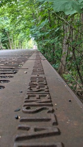 A metal flat ground is visible with text naming how many Jews from which location were deported here