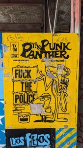 Stereotypical drawing of Pink Panther where pink panther writes the text “Fuck the police” on a wall