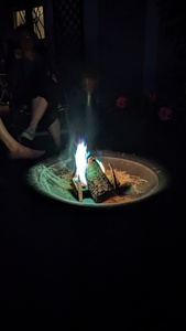 Photo during the dark night with bright flames in a campfire