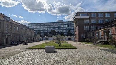 A photo outside the buildings of museum with a tiny garden in the middle