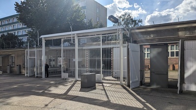 A white 5 metre tall metal fence is pictured