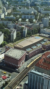 A view from the tower is shown where buildings and roads and cars are understandingly tiny