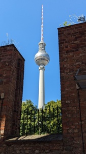 The TV tower Berlin is visible in the center in between brick walls