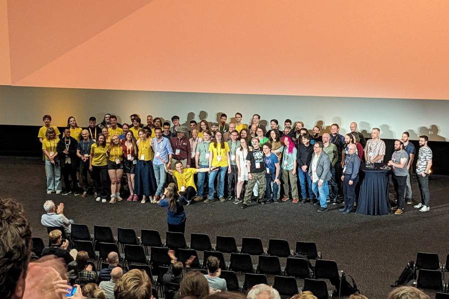 RustWeek organizers gathered at the front stage in a cinema room to take a final conference photo together